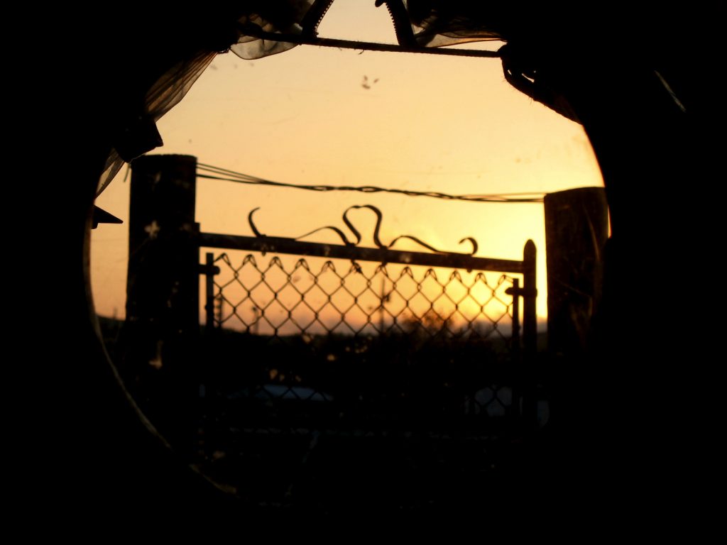 View of a gate through the wagon window.