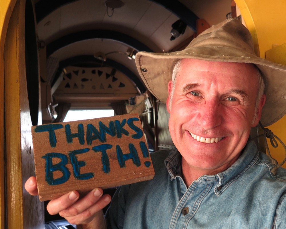 Bernie holds sign in wagon.